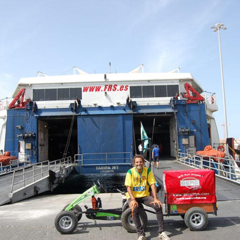 Pedal Joe with his BERG pedal kart and trailer in front of an FRS ferry at the port