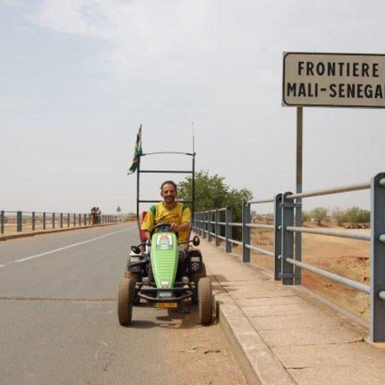 Pedal Joe with his BERG pedal kart at the border crossing between Mali and Senegal