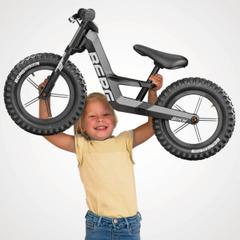 Child lifts lightweight BERG Biky Cross balance bike, robust and maneuverable design